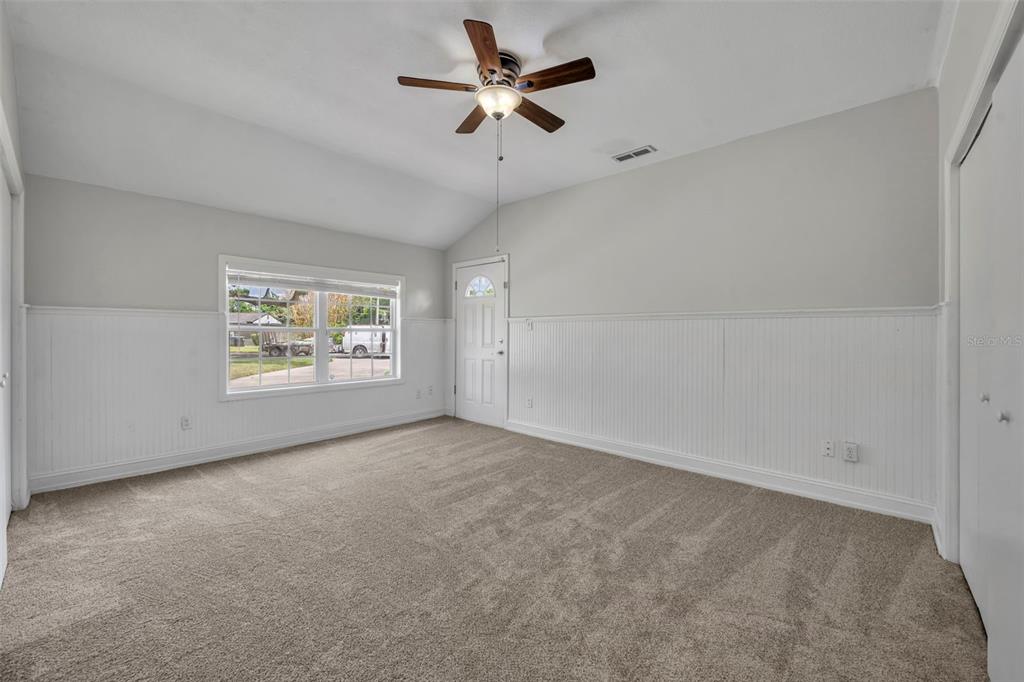 4234 Kendrick Road Orlando, FL 32804 - Photo 23 of 46 an empty room with windows and fan