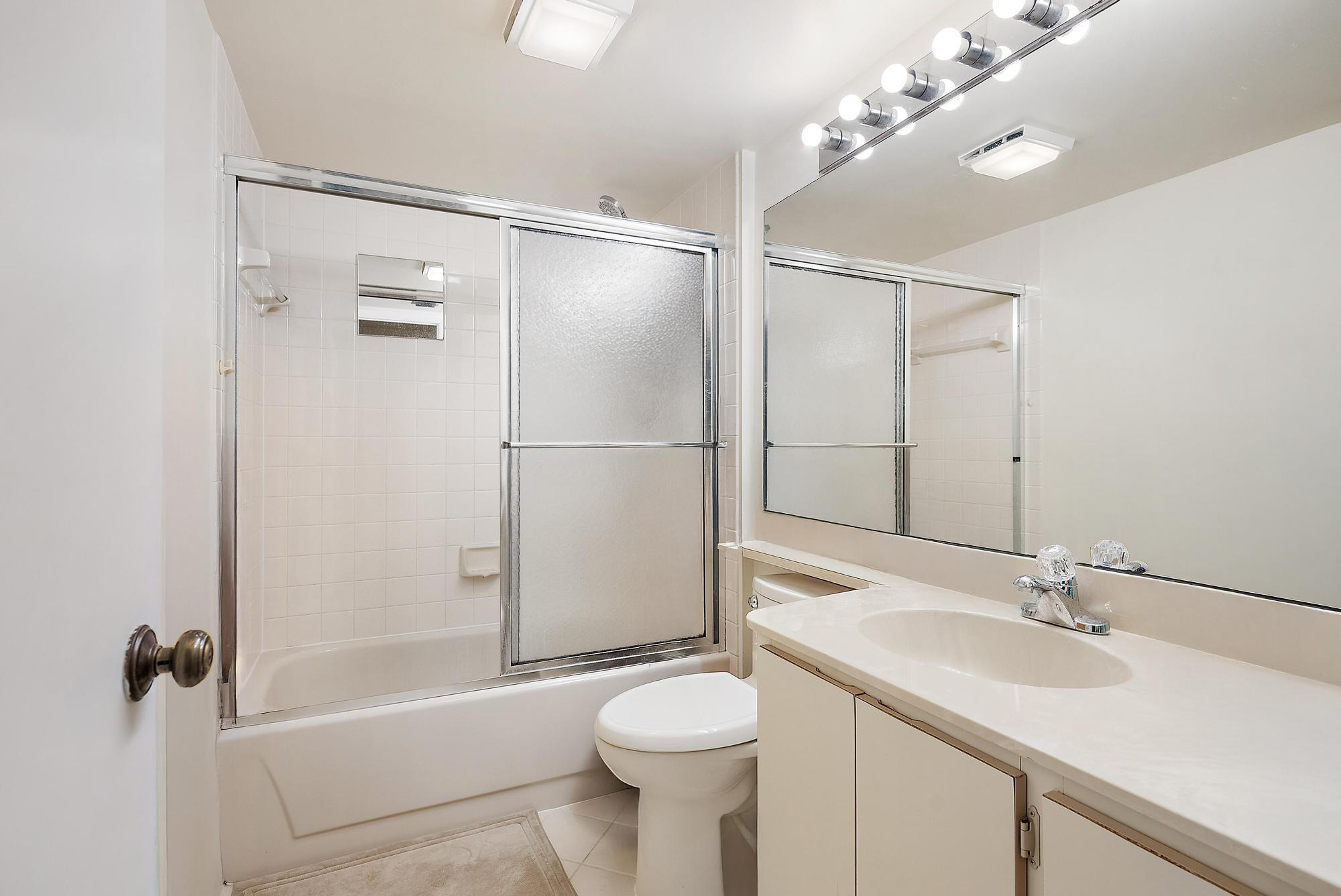 2761 Village Boulevard, Unit 303 West Palm Beach, FL 33409 - Photo 11 of 12 a bathroom with a sink toilet and shower