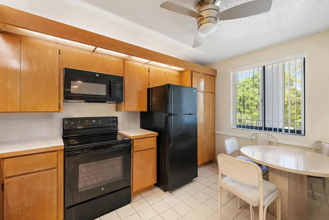 a kitchen with stainless steel appliances a stove microwave and refrigerator