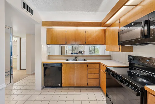 a kitchen with stainless steel appliances granite countertop a sink and a stove