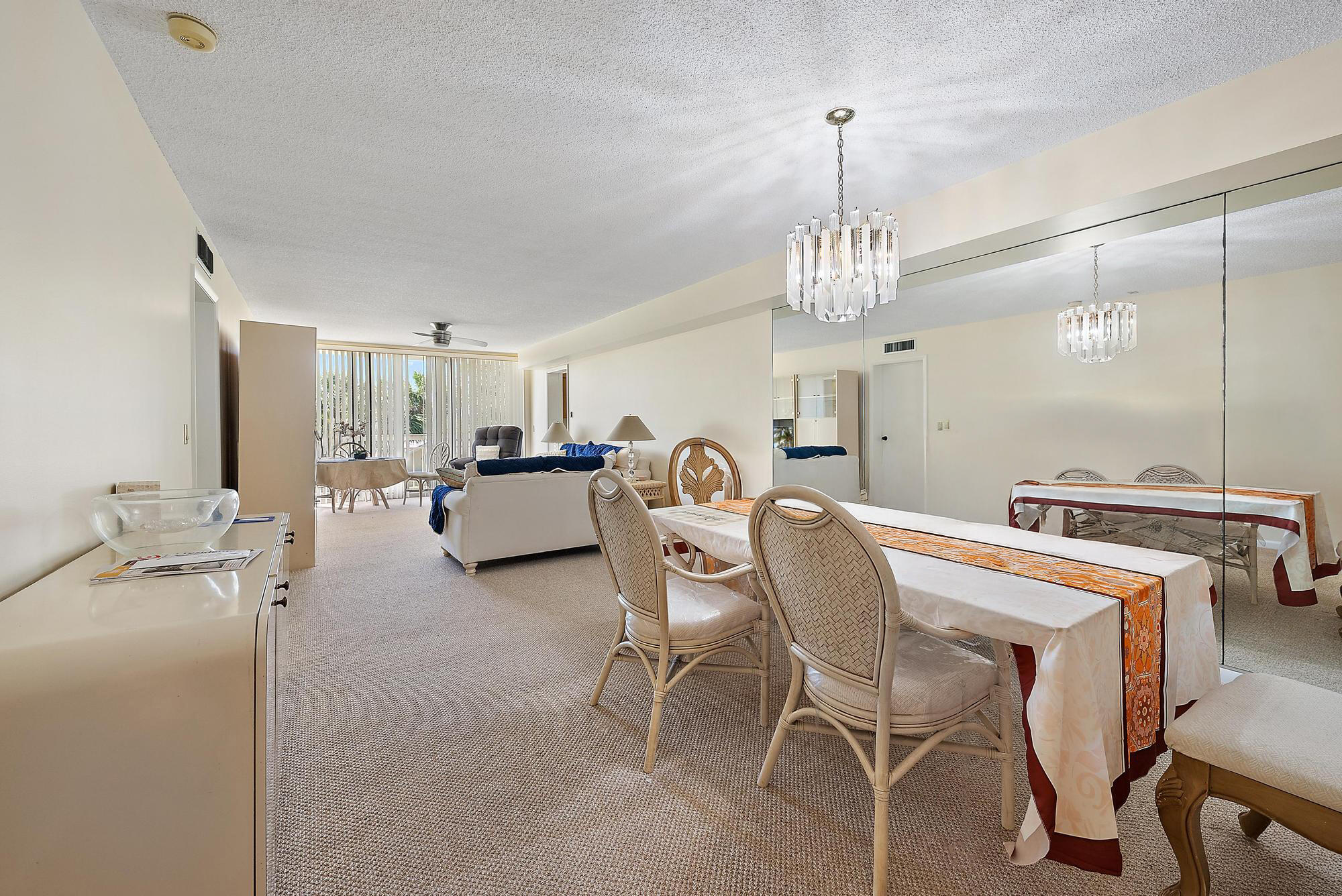 2761 Village Boulevard, Unit 303 West Palm Beach, FL 33409 - Photo 5 of 12 a living room with furniture and a chandelier