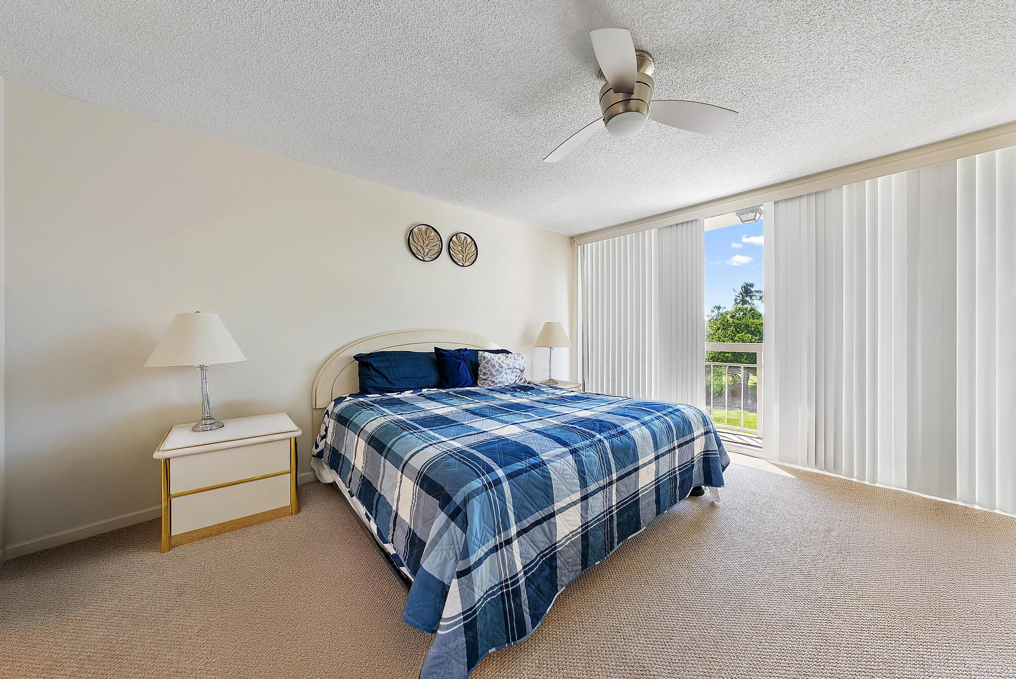 2761 Village Boulevard, Unit 303 West Palm Beach, FL 33409 - Photo 6 of 12 a bedroom with a bed and window