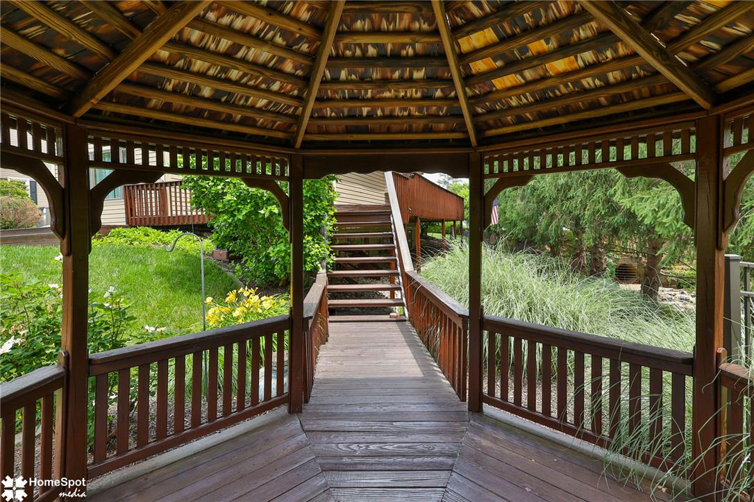 2821 Center Street Bethlehem, PA 18017 - Photo 67 of 68 A charming wooden gazebo offers a delightful outdoor retreat, leading to elevated walkways and lush natural surroundings.