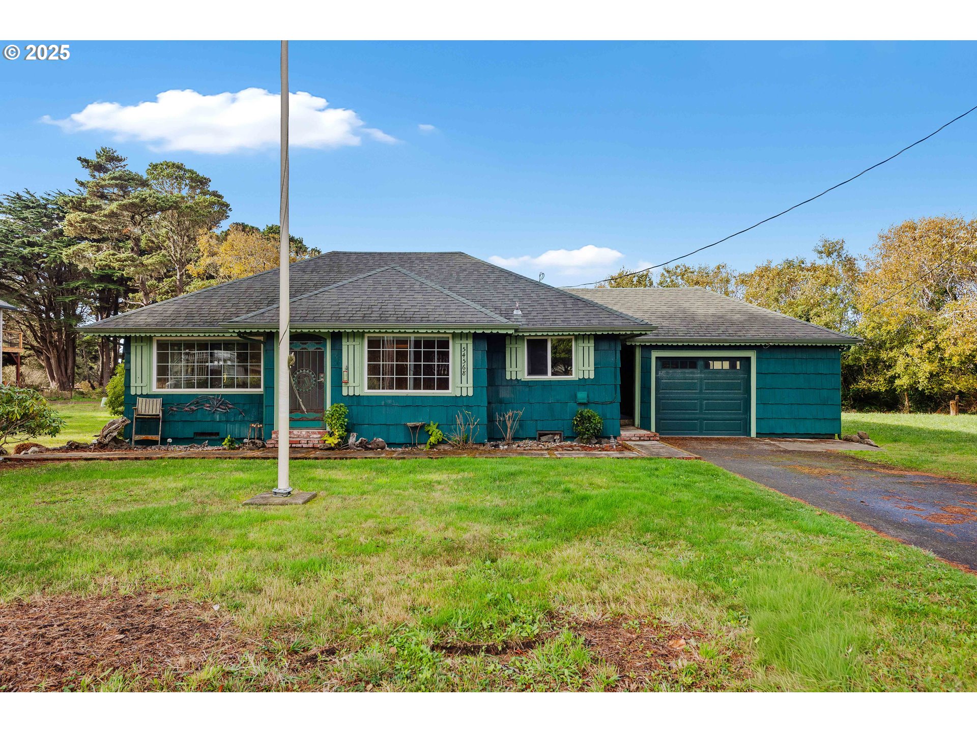 54568 Beach Loop Road Bandon, OR 97411 - Photo 12 of 38 a front view of a house with a yard