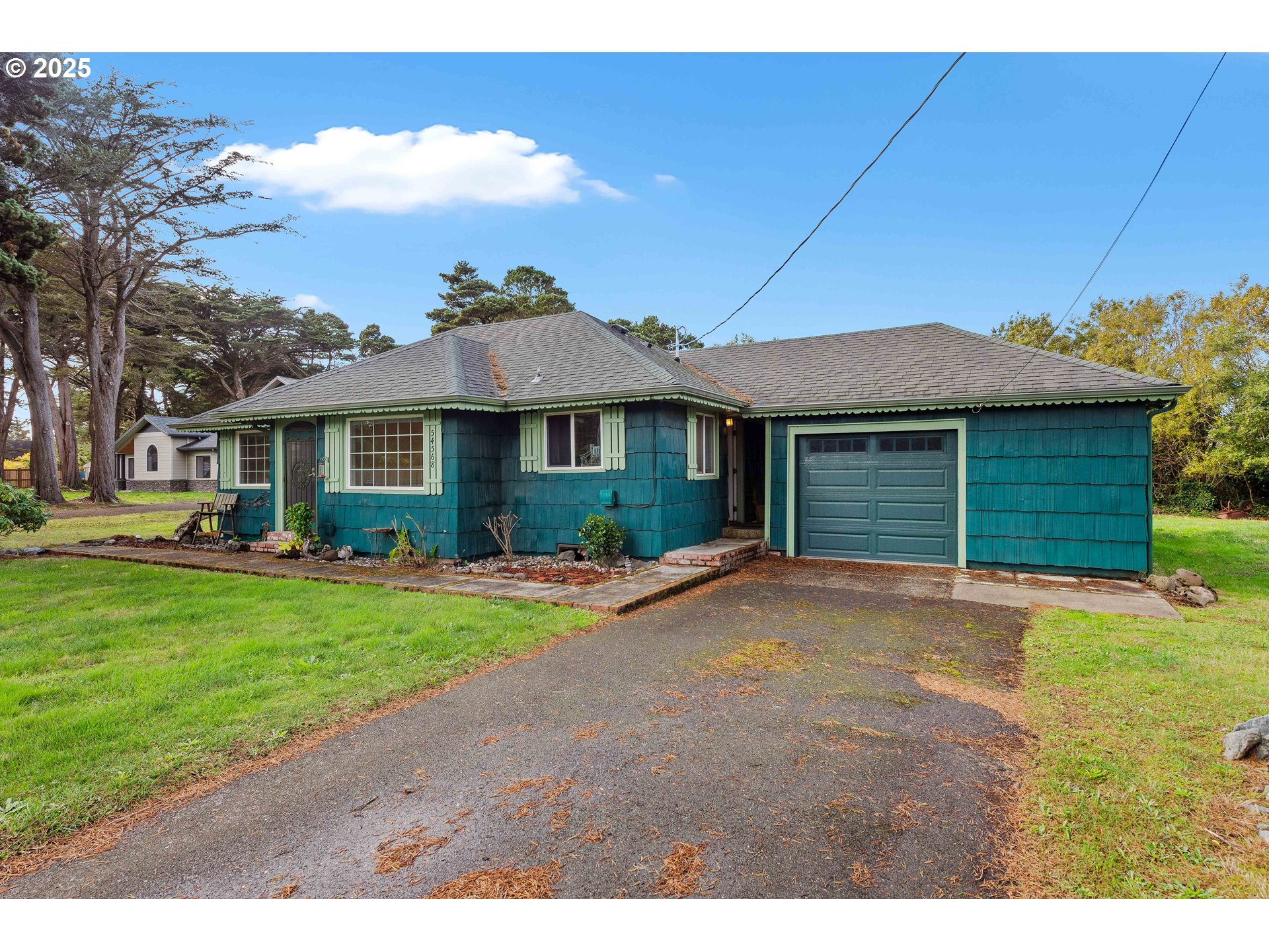 54568 Beach Loop Road Bandon, OR 97411 - Photo 14 of 38 a front view of a house with a garden