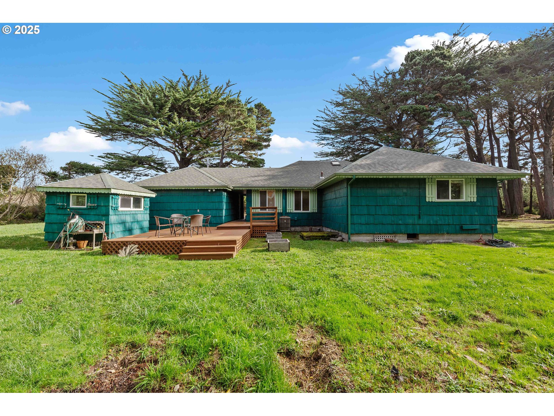 54568 Beach Loop Road Bandon, OR 97411 - Photo 18 of 38 a front view of a house with a garden