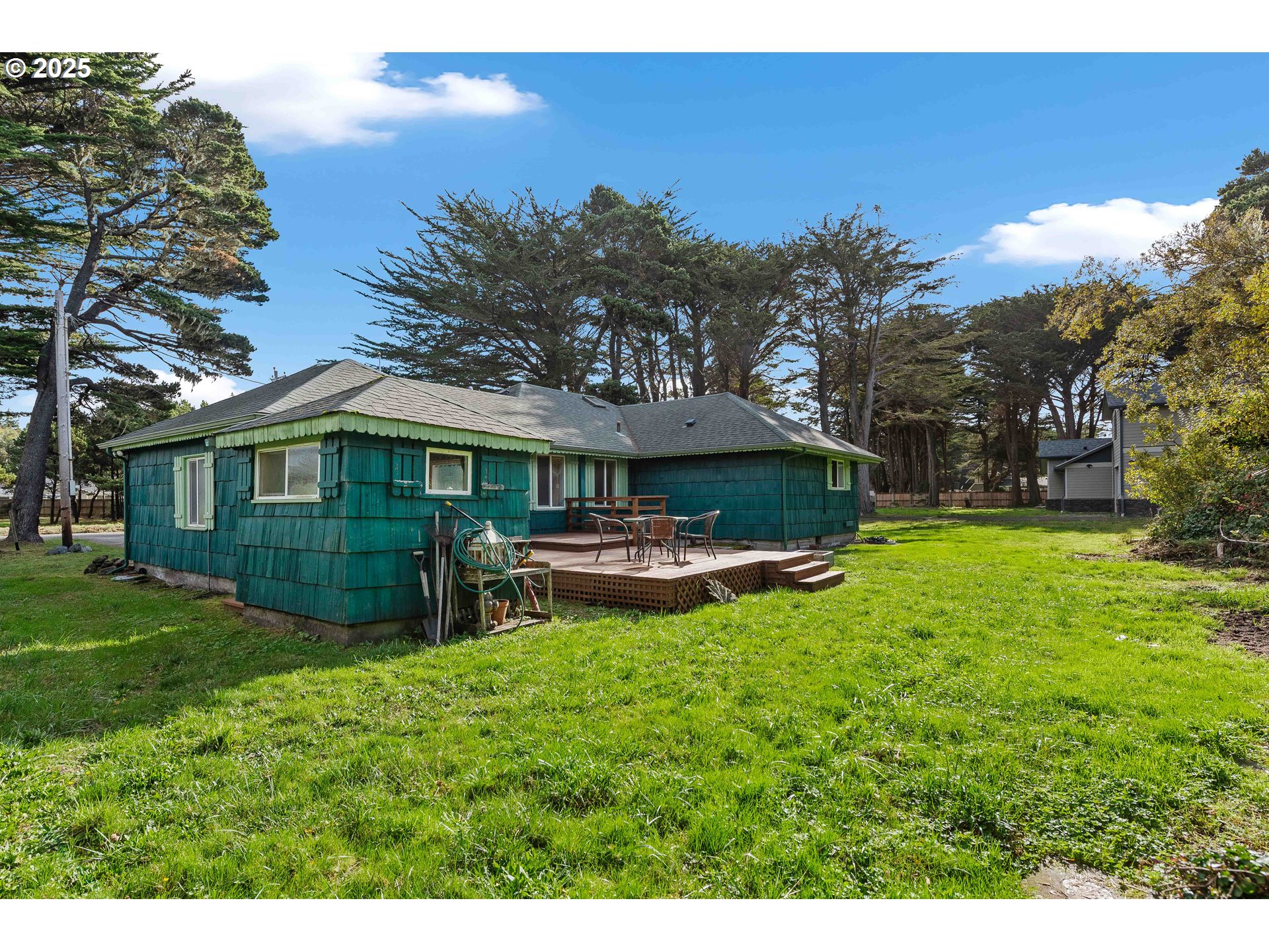54568 Beach Loop Road Bandon, OR 97411 - Photo 20 of 38 a view of a house with a yard porch and sitting area