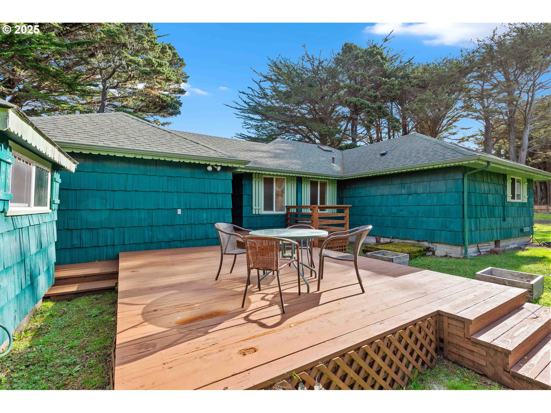 54568 Beach Loop Road Bandon, OR 97411 - Photo 21 of 38 a view of a patio with a table and chairs under an umbrella