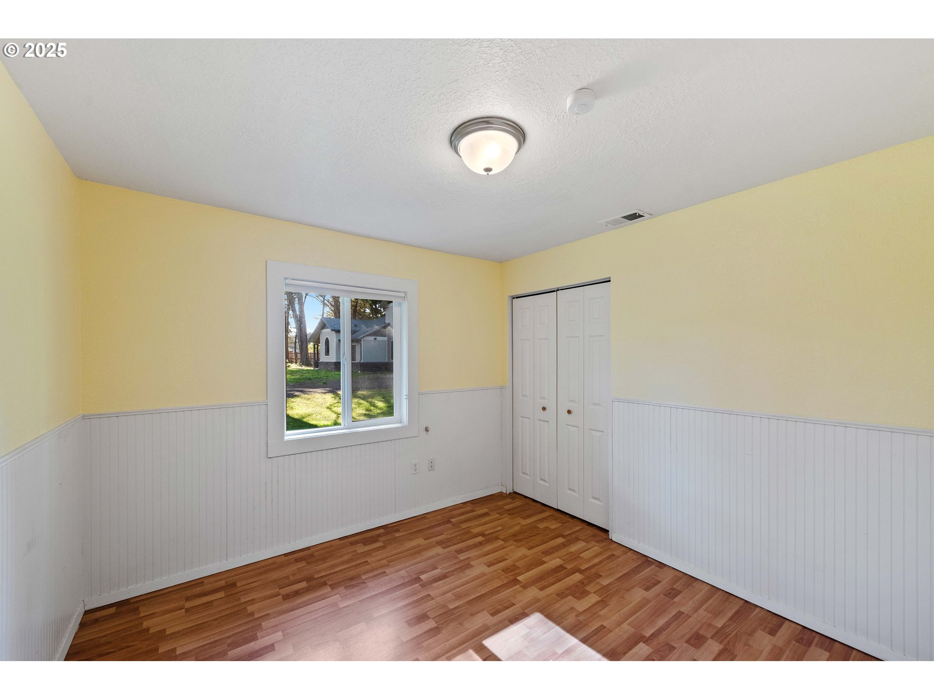 54568 Beach Loop Road Bandon, OR 97411 - Photo 34 of 38 a view of an empty room with wooden floor and a window