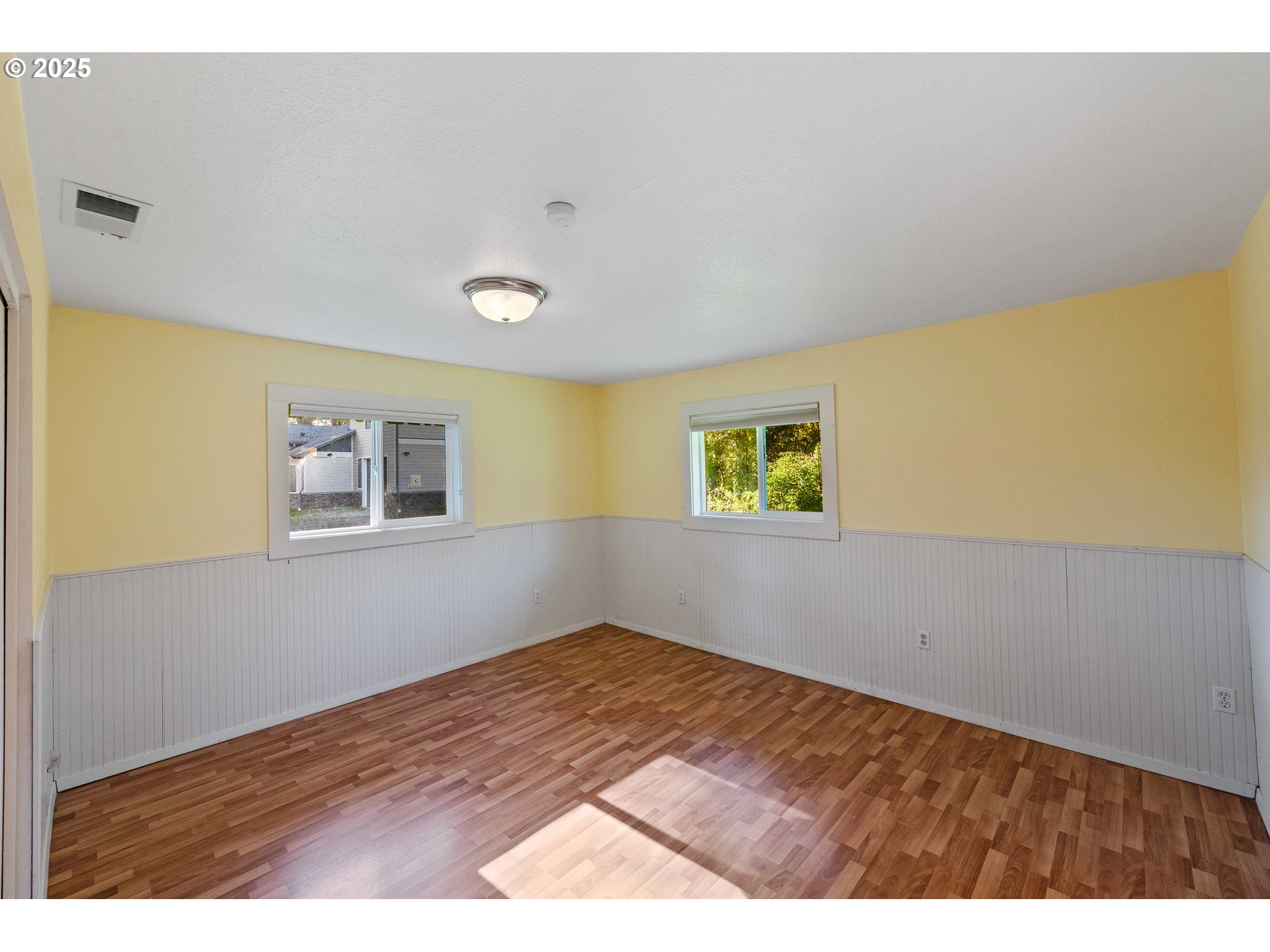 54568 Beach Loop Road Bandon, OR 97411 - Photo 37 of 38 a view of empty room with wooden floor