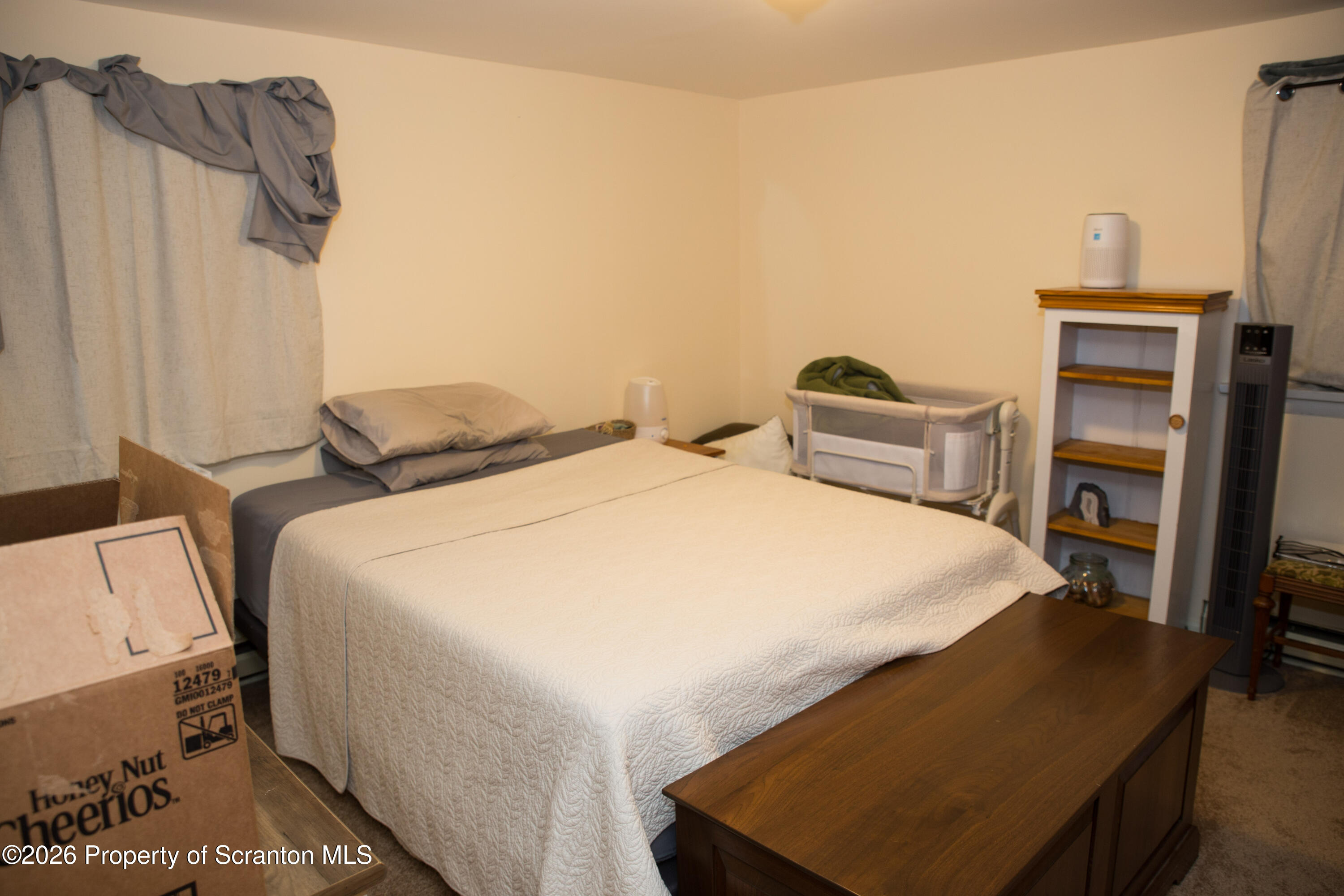 5411 Bloomington Road Moscow, PA 18444 - Photo 3 of 7 a spacious bedroom with a bed and a flat screen tv