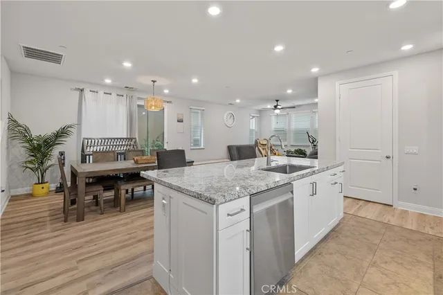 a large kitchen with kitchen island a sink table and chairs