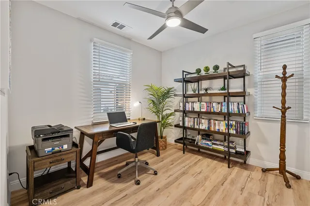 a view of a workspace with furniture and a window