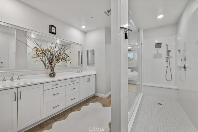 a bathroom with a granite countertop sink a shower and a mirror
