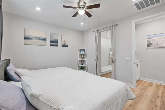 a bedroom with a large bed and a chandelier