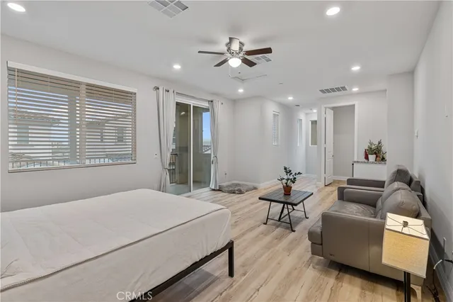 a spacious bedroom with a bed and furniture