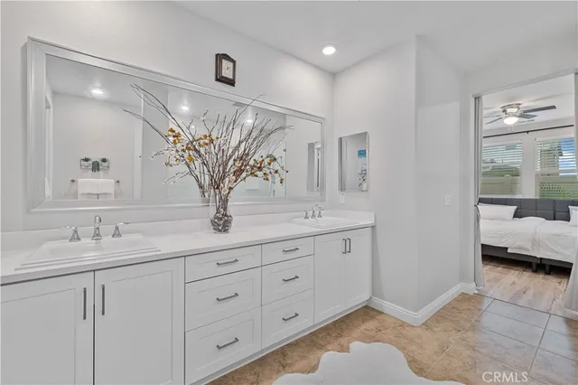 a bathroom with a granite countertop sink a mirror and a shower