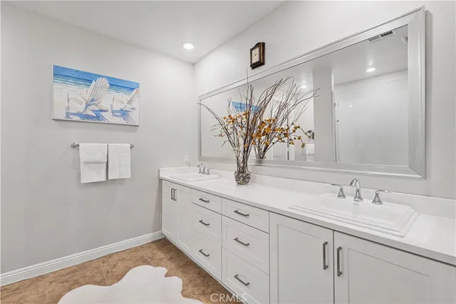 a bathroom with a double vanity sink and a mirror