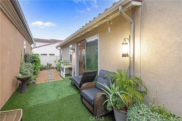 a view of backyard with outdoor seating and plants