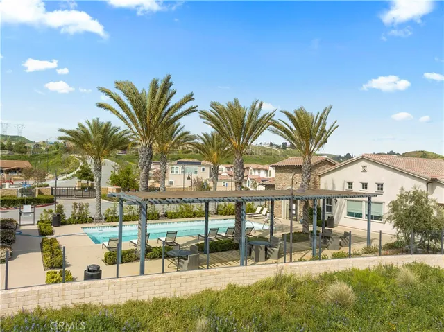 a view of a swimming pool with a table and chairs