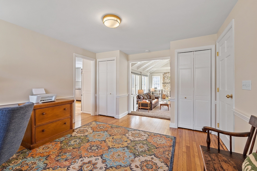 551 Barretts Mill Road Concord, MA 01742 - Photo 17 of 36 a bedroom with furniture and a wooden floor