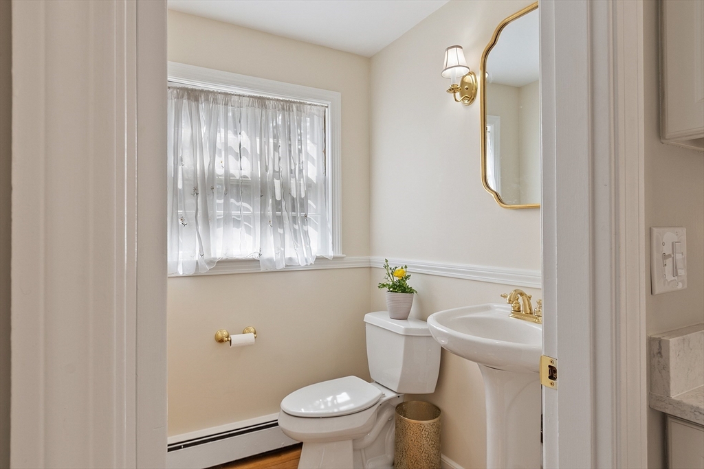 551 Barretts Mill Road Concord, MA 01742 - Photo 19 of 36 a white toilet sitting next to a bathroom sink