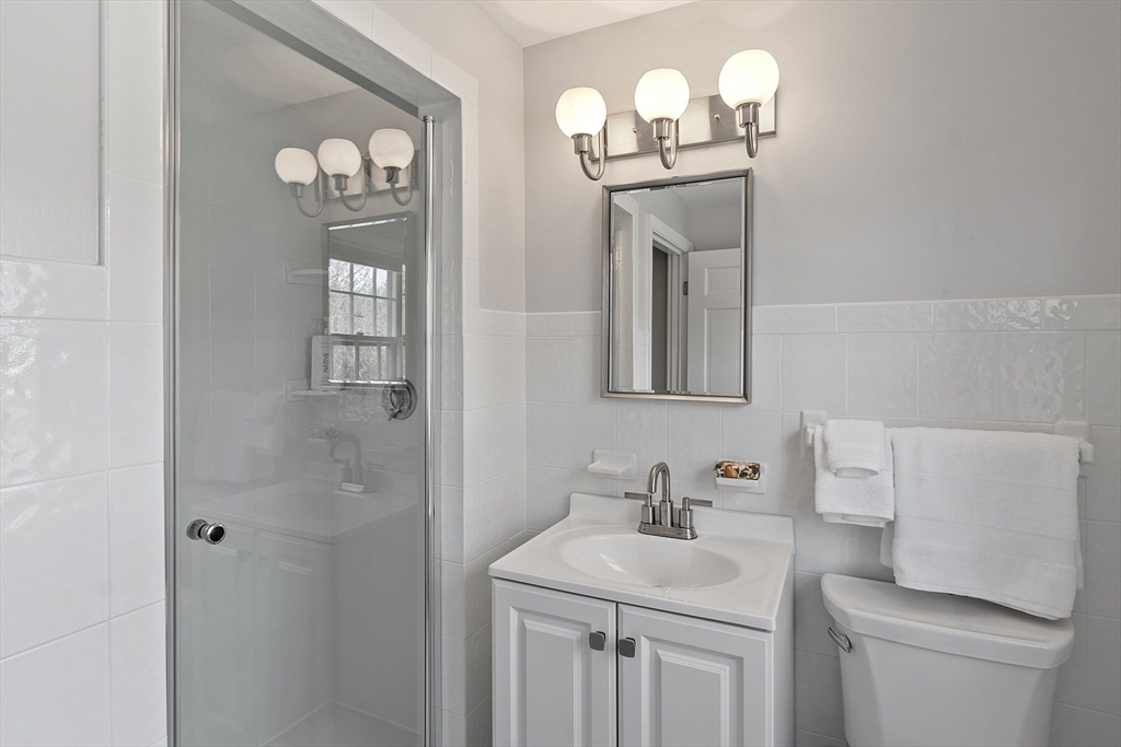 551 Barretts Mill Road Concord, MA 01742 - Photo 23 of 36 a bathroom with a sink a mirror and a toilet