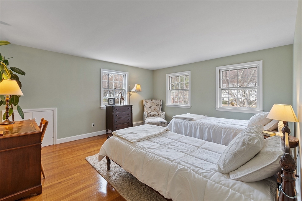 551 Barretts Mill Road Concord, MA 01742 - Photo 24 of 36 a bedroom with a bed and wooden floor