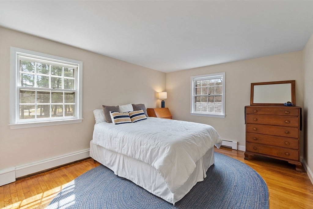 551 Barretts Mill Road Concord, MA 01742 - Photo 25 of 36 a bedroom with a bed and a dresser