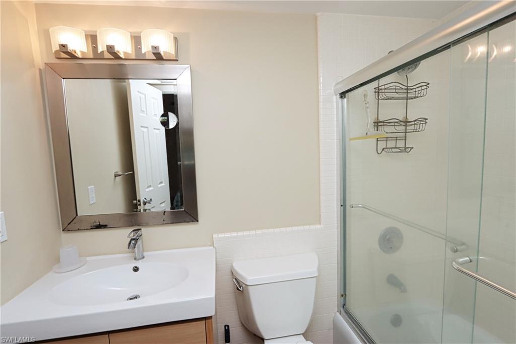 820 Ketch Drive, Unit 3 Naples, FL 34103 - Photo 16 of 19 a bathroom with a sink a toilet and shower