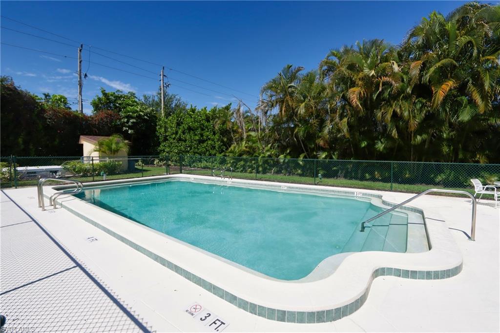 820 Ketch Drive, Unit 3 Naples, FL 34103 - Photo 17 of 19 a swimming pool with yard and outdoor seating
