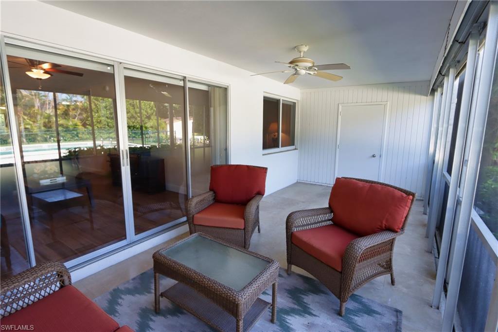 820 Ketch Drive, Unit 3 Naples, FL 34103 - Photo 2 of 19 a living room with furniture and a floor to ceiling window