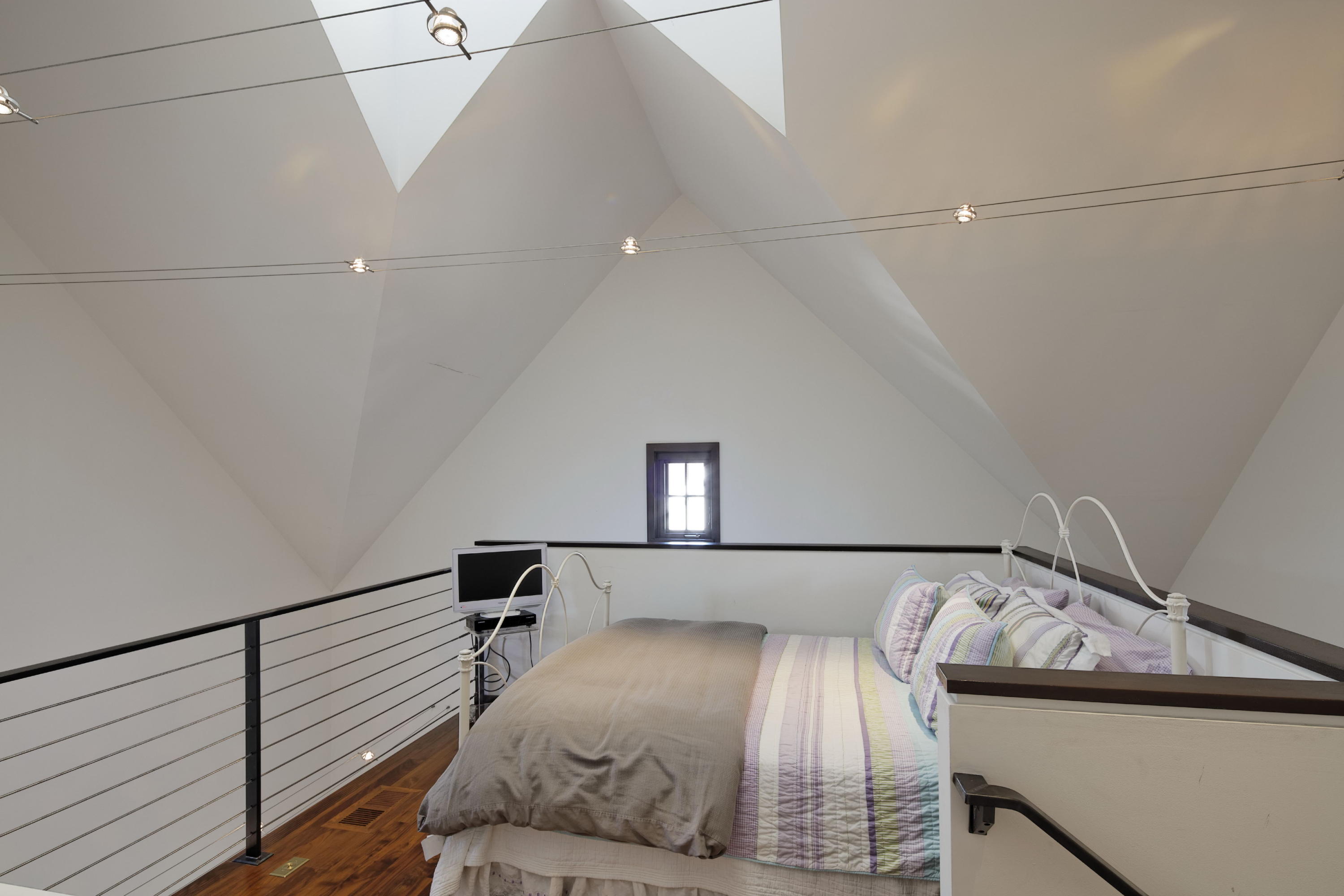 1-2 Rocky Point Road Rowayton, CT 06853 - Photo 24 of 35 a bedroom with a bed and wooden floor