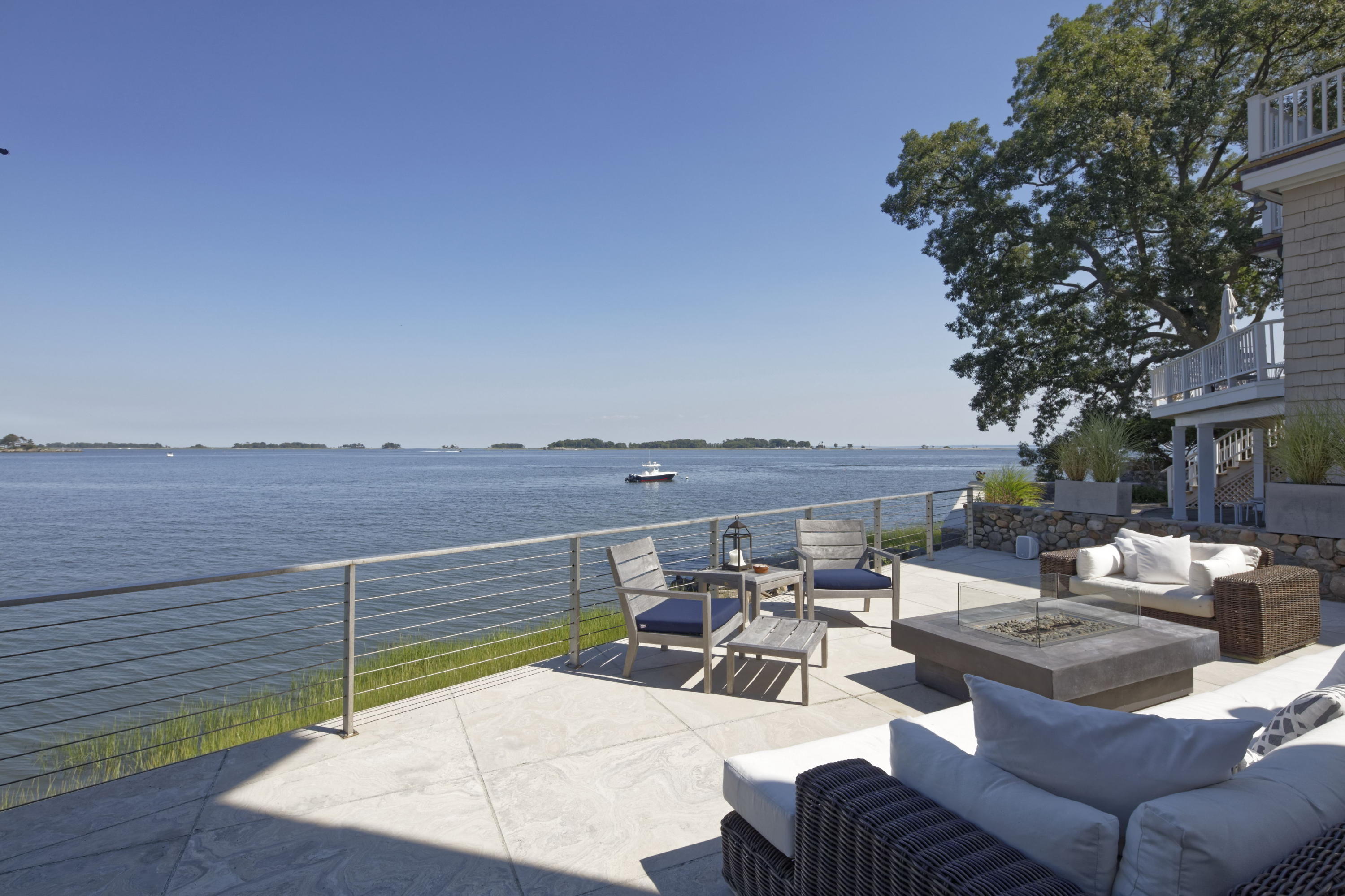 1-2 Rocky Point Road Rowayton, CT 06853 - Photo 3 of 35 a view of a terrace with furniture and a fire pit
