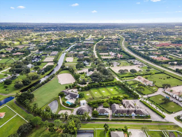 an aerial view of residential houses with outdoor space and swimming pool