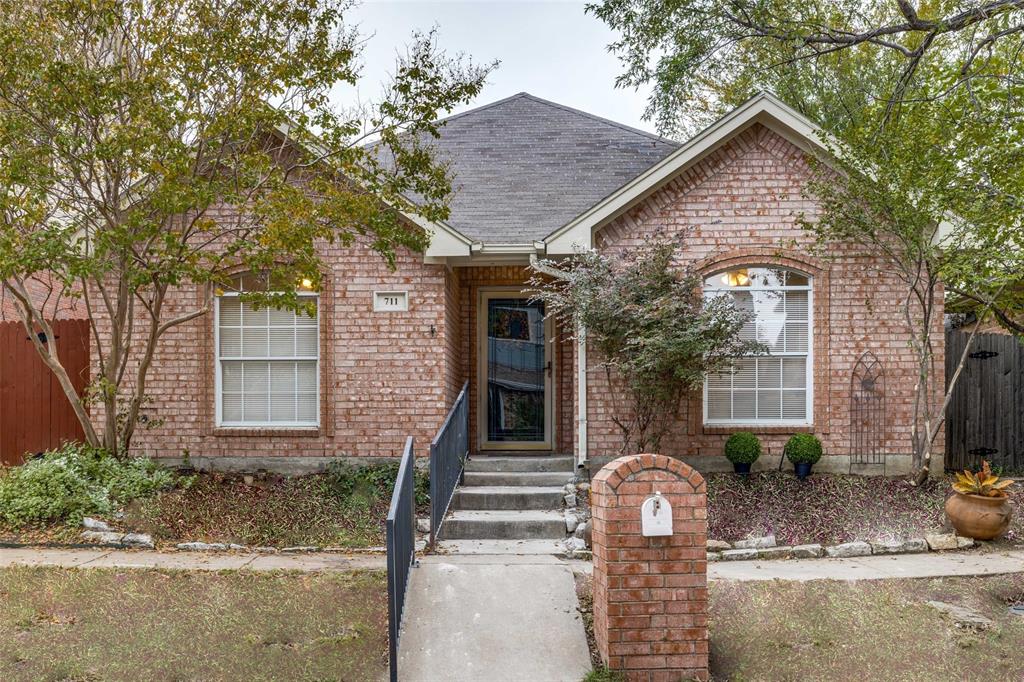 711 Greenridge Drive Arlington, TX 76017 - Photo 1 of 1 a front view of a house with garden