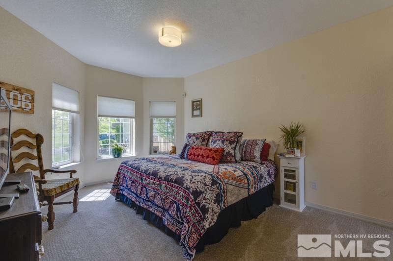 2245 Wide Horizon Drive Reno, NV 89509 - Photo 11 of 25 a bedroom with a bed a couch and dresser