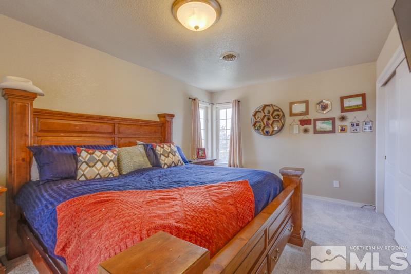 2245 Wide Horizon Drive Reno, NV 89509 - Photo 17 of 25 a bed sitting in a bedroom next to a window