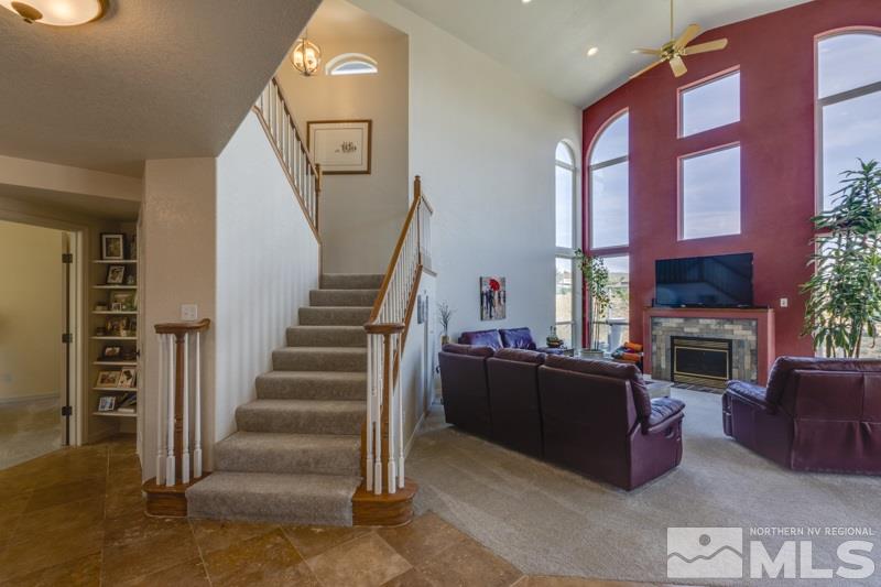2245 Wide Horizon Drive Reno, NV 89509 - Photo 3 of 25 a living room with furniture a fireplace and a flat screen tv