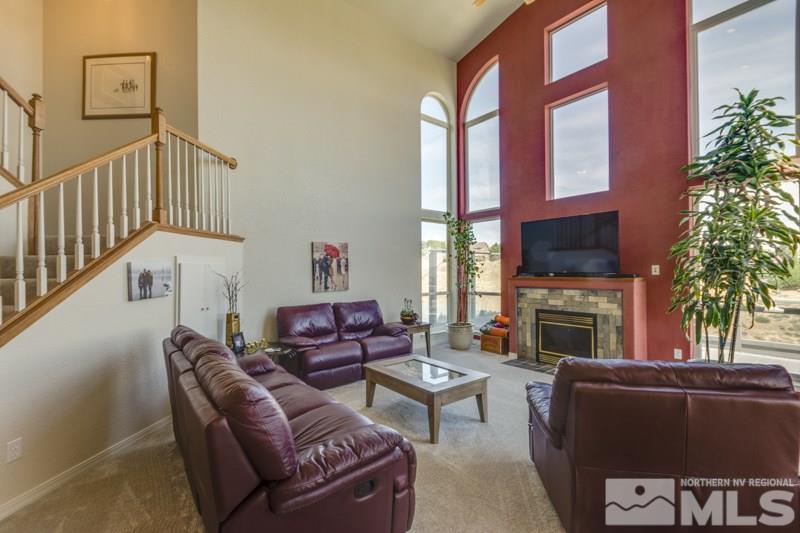 2245 Wide Horizon Drive Reno, NV 89509 - Photo 4 of 25 a living room with furniture a fireplace and a flat screen tv