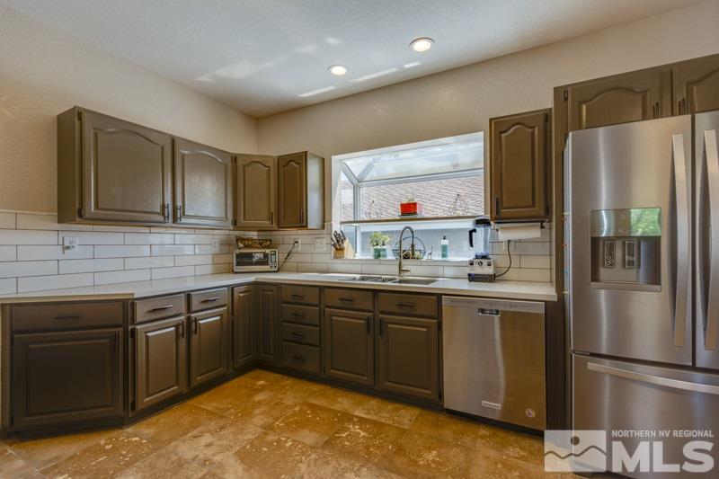 2245 Wide Horizon Drive Reno, NV 89509 - Photo 7 of 25 a kitchen with stainless steel appliances granite countertop a refrigerator and a stove top oven