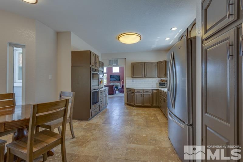 2245 Wide Horizon Drive Reno, NV 89509 - Photo 8 of 25 a kitchen with stainless steel appliances granite countertop a refrigerator and a stove top oven