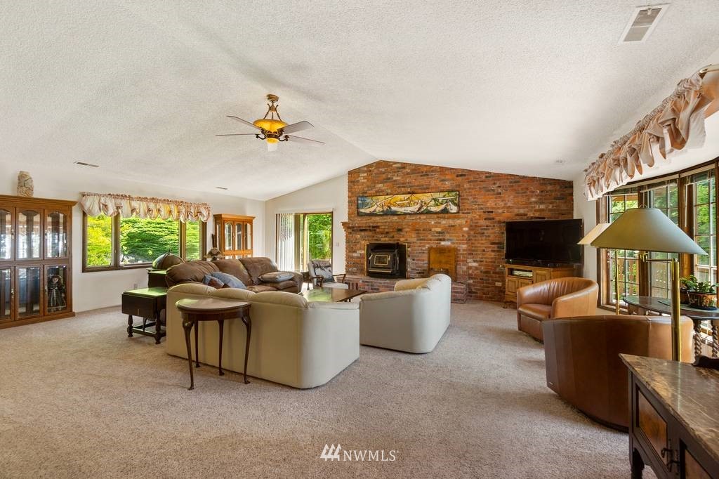 1624 King Road Winlock, WA 98596 - Photo 12 of 39 a living room with furniture a fireplace and large windows