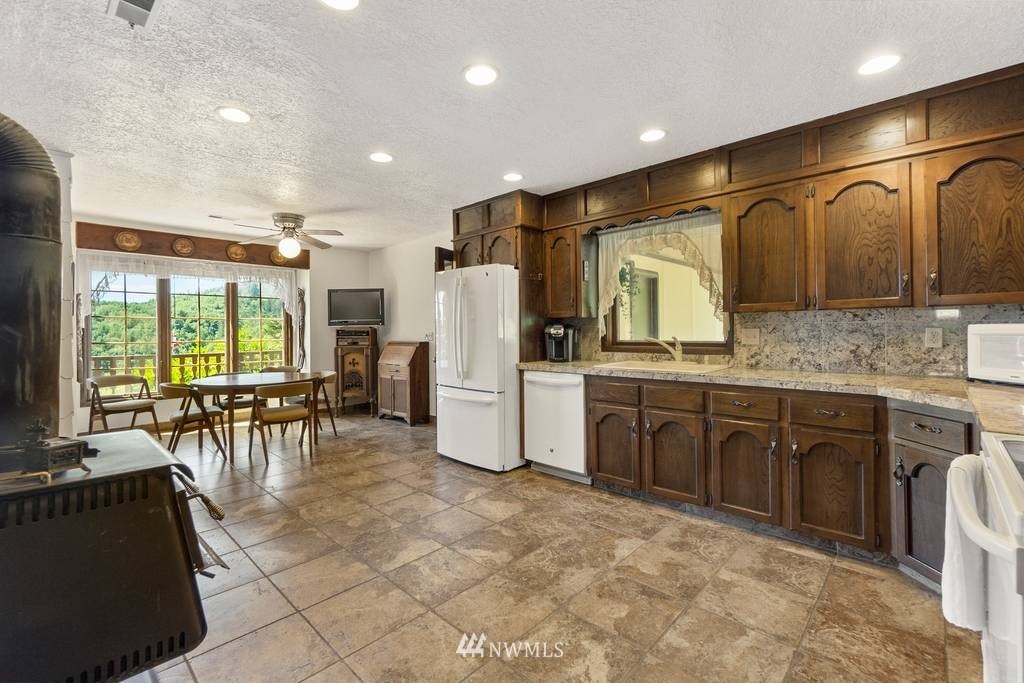 1624 King Road Winlock, WA 98596 - Photo 19 of 39 a kitchen with refrigerator cabinets and chairs
