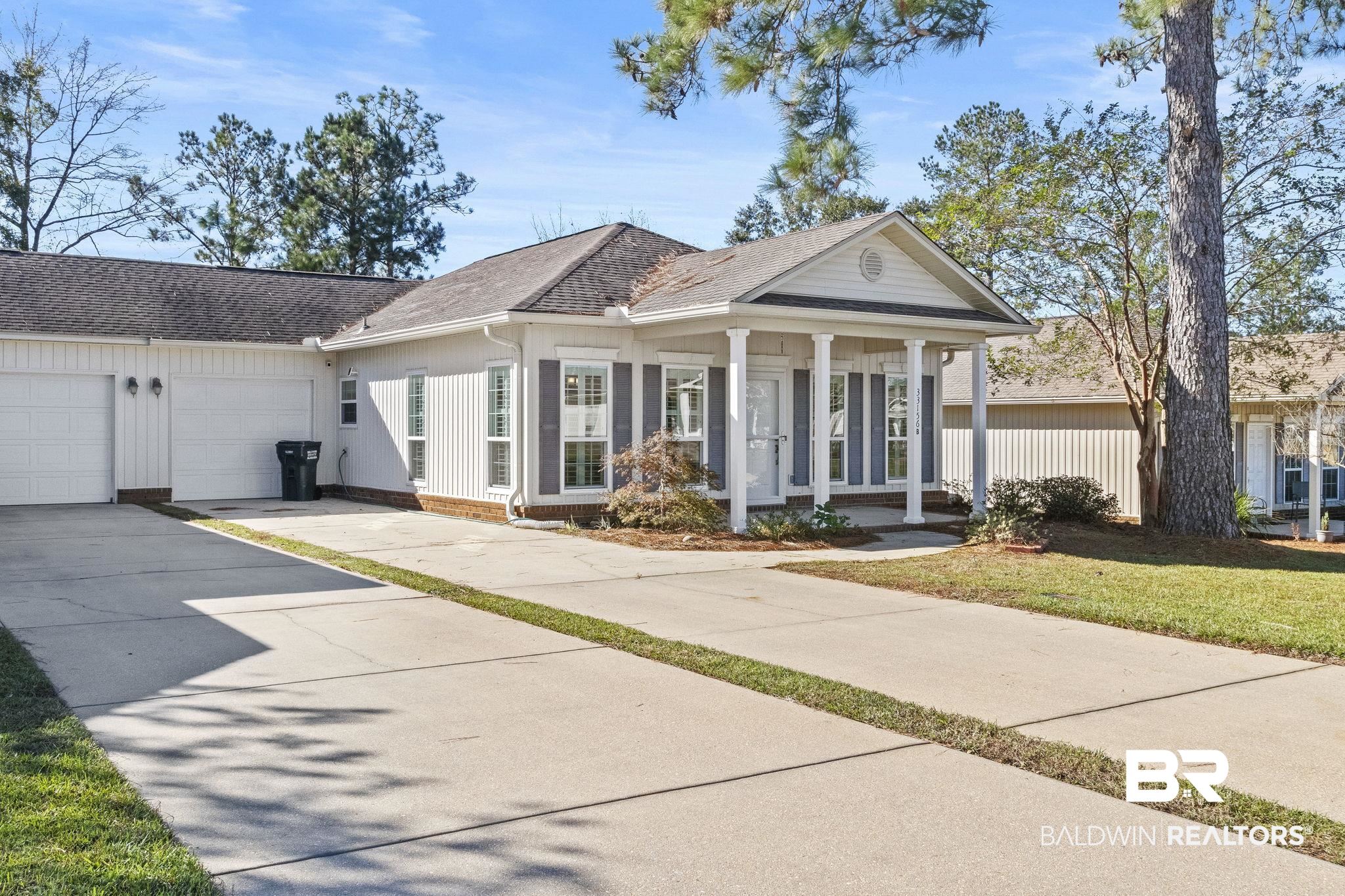 33156 Stables Drive, Unit 7B Daphne, AL 36527 - Photo 2 of 31 View of front of home featuring covered porch and a garage
