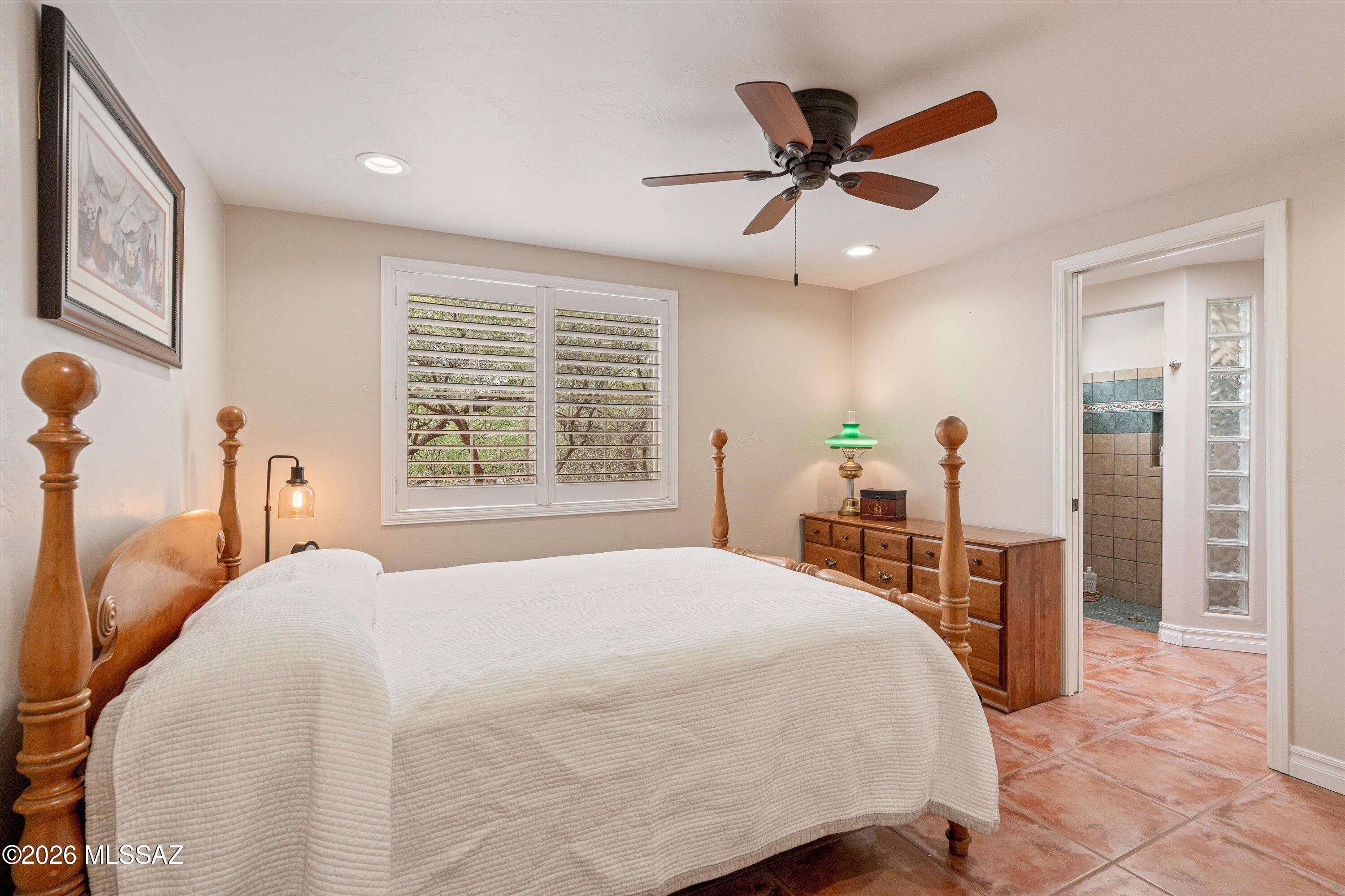 4760 East Wagon Train Road Tucson, AZ 85739 - Photo 27 of 38 a bedroom with a bed and window