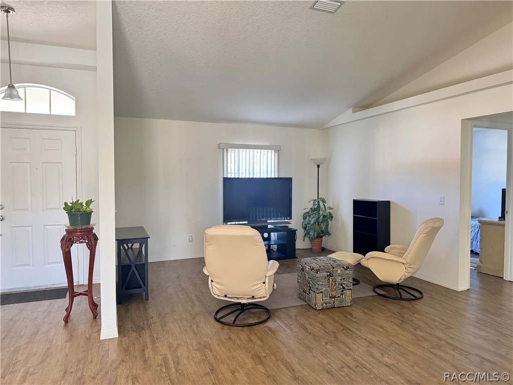 4588 East Van Ness Road Inverness, FL 34453 - Photo 16 of 34 a living room with furniture and a chair