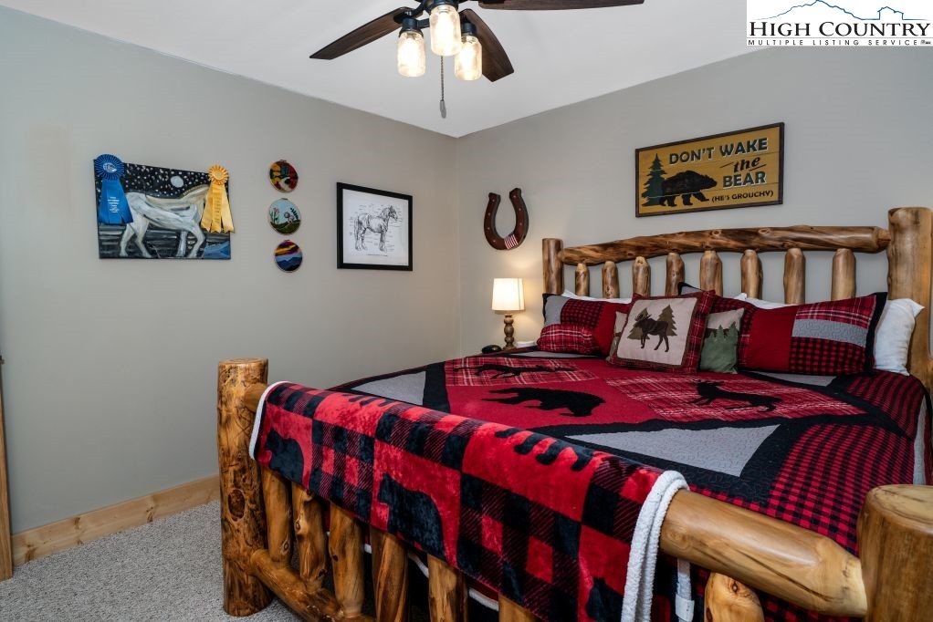 25 Red Oak Road Newland, NC 28657 - Photo 40 of 45 a bedroom with a bed a painting on the wall and a large window