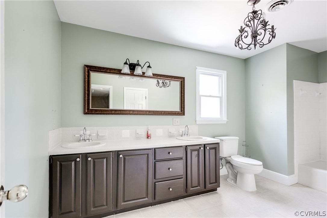 9641 Pasture Hill Road Midlothian, VA 23112 - Photo 27 of 30 a bathroom with a toilet sink and mirror