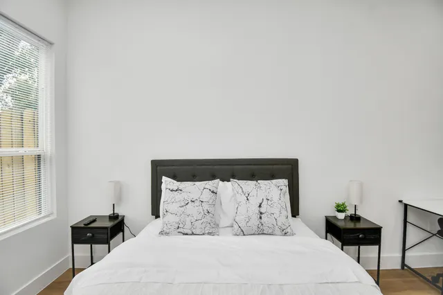 a bedroom with a bed and a chandelier